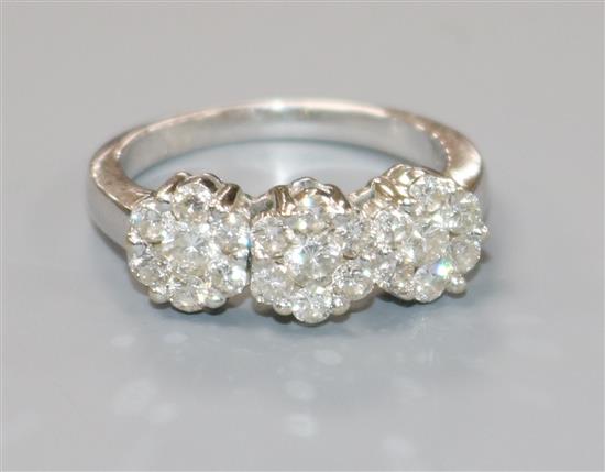 A triple cluster diamond ring (approx 1.02ct total) on white gold shank (tests as 18ct), size O/P
